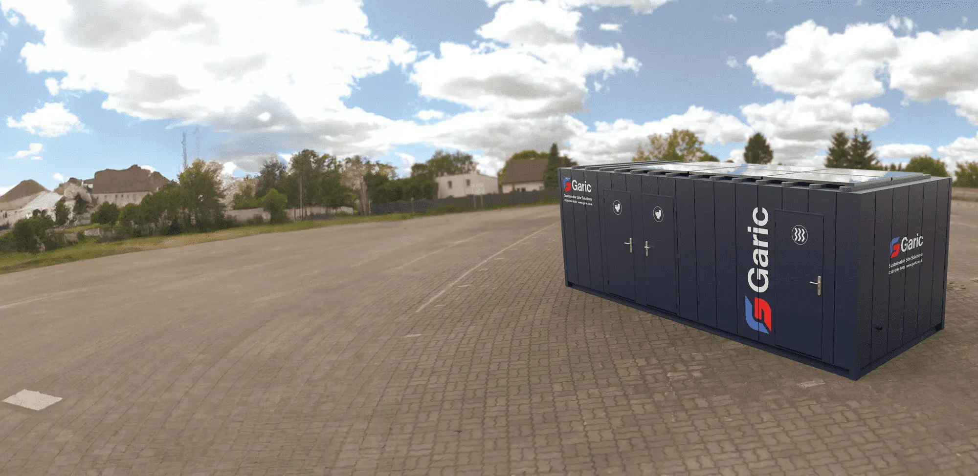 A 2+1+Dryer 24 Eco modular unit in dark blue is positioned on a paved lot under a partly cloudy sky, with houses visible in the background.