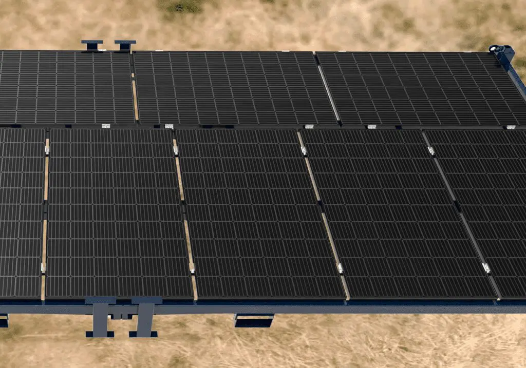 Close-up view of several Solar Power Frame black solar panels installed outdoors on a brown grassy surface.