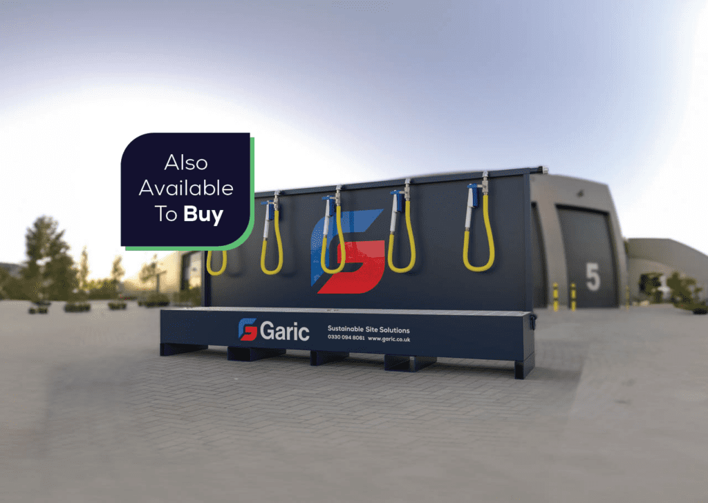 Large industrial Bootwash equipment with hoses, labeled Garic, outside a warehouse; sign reads Also Available To Buy.