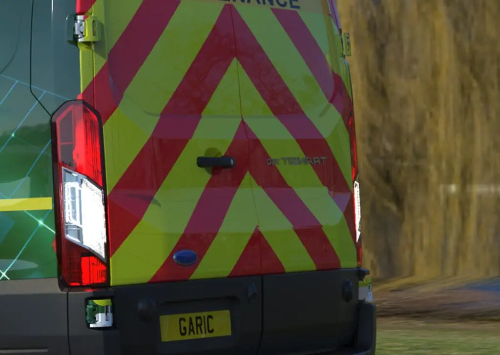Rear of a Welfare Van Eco+ with red and yellow chevrons and a license plate reading GARIC.
