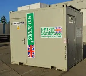 Beige portable drying room unit with ECO SERIES+ and UK flag decals, parked on a concrete surface.