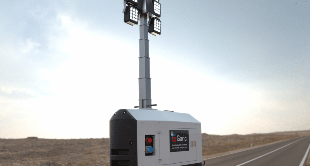 An Eco Tower Light stands beside a deserted road in a dry, open landscape.