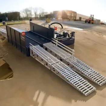 Enviro Wheel Wash 24 set up outdoors on a concrete surface with sunlight in the background.