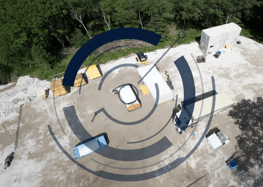 Aerial view highlighting vehicles, equipment, and temporary buildings at a construction site, overlaid with blue circles to showcase Solar Energy Store 20.