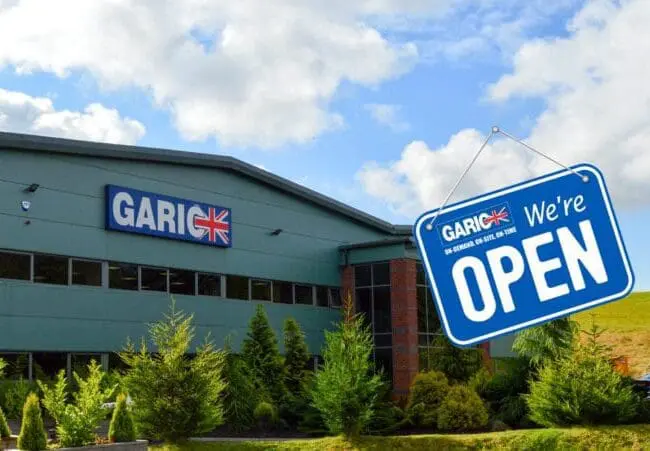 A building with a GARIC sign and a blue Were Open sign hanging in front.