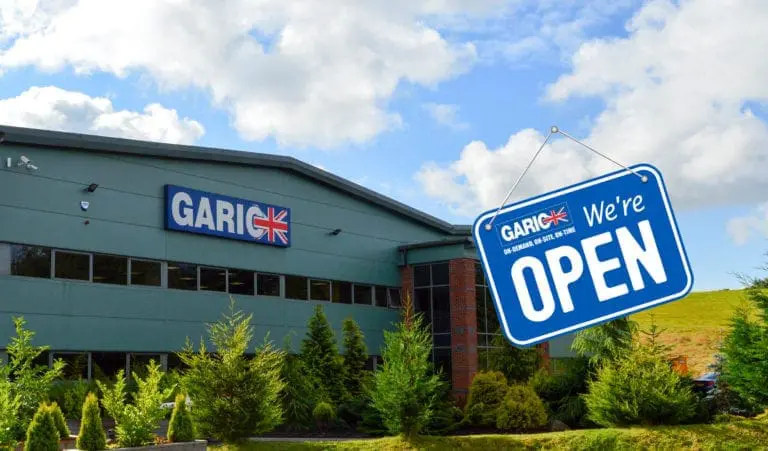 A building with a GARIC sign and a blue Were Open sign hanging in front.