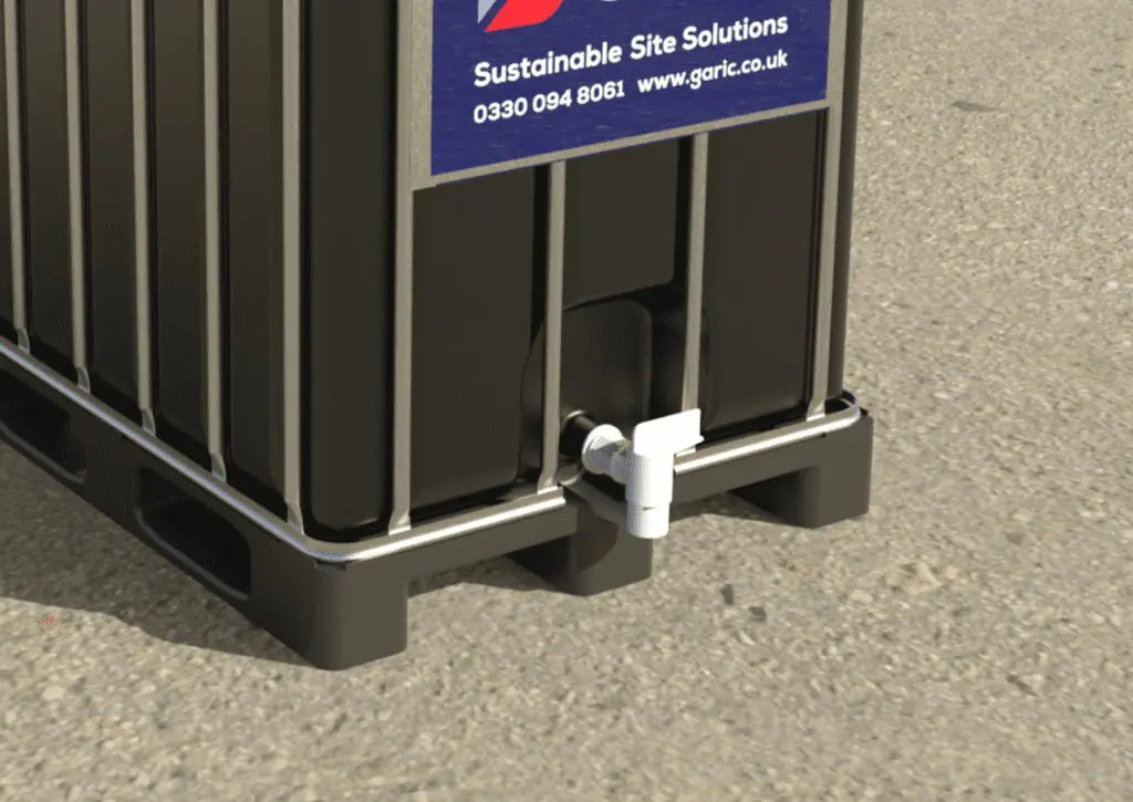 Close-up of the Solar IBC 1000, a black container with a white tap at the base, placed on a concrete surface.