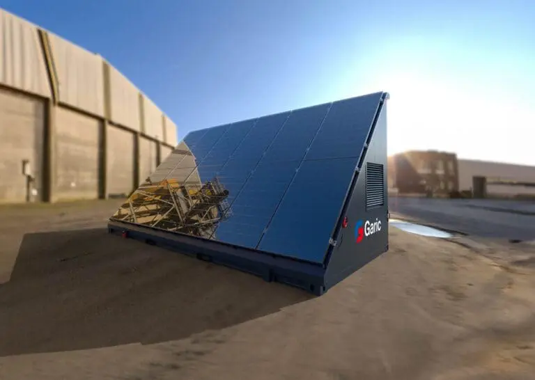 A Solar Energy Store 20 portable solar panel unit is set up on an industrial site beneath a clear blue sky.