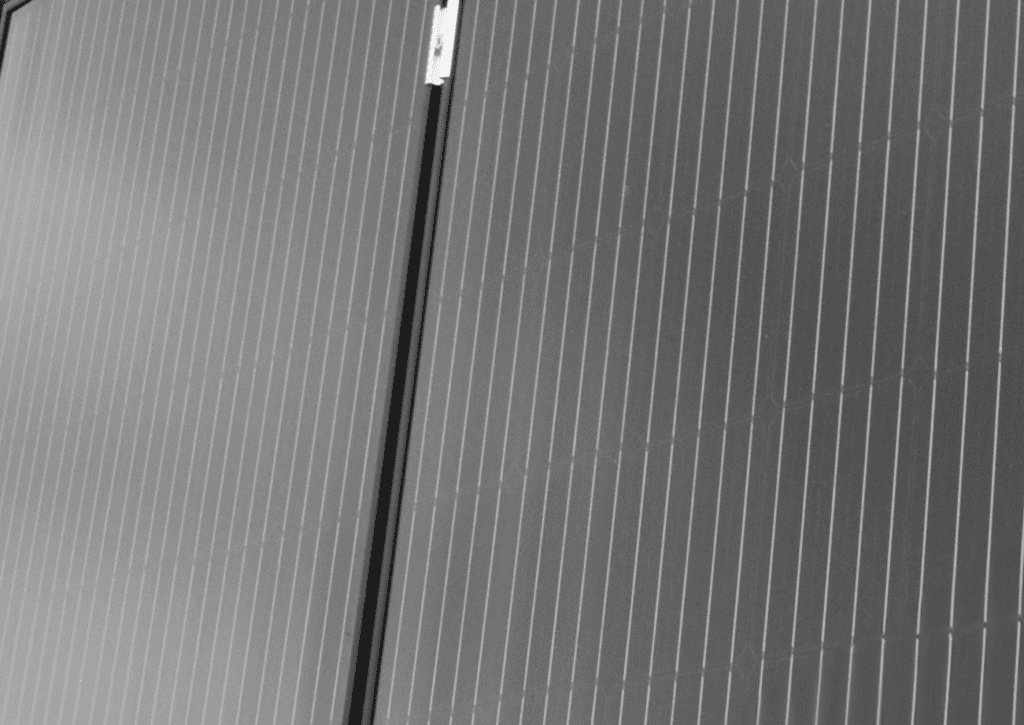 Close-up of two Solar Loo 8 panels side by side, highlighting their dark surfaces with vertical grid lines.
