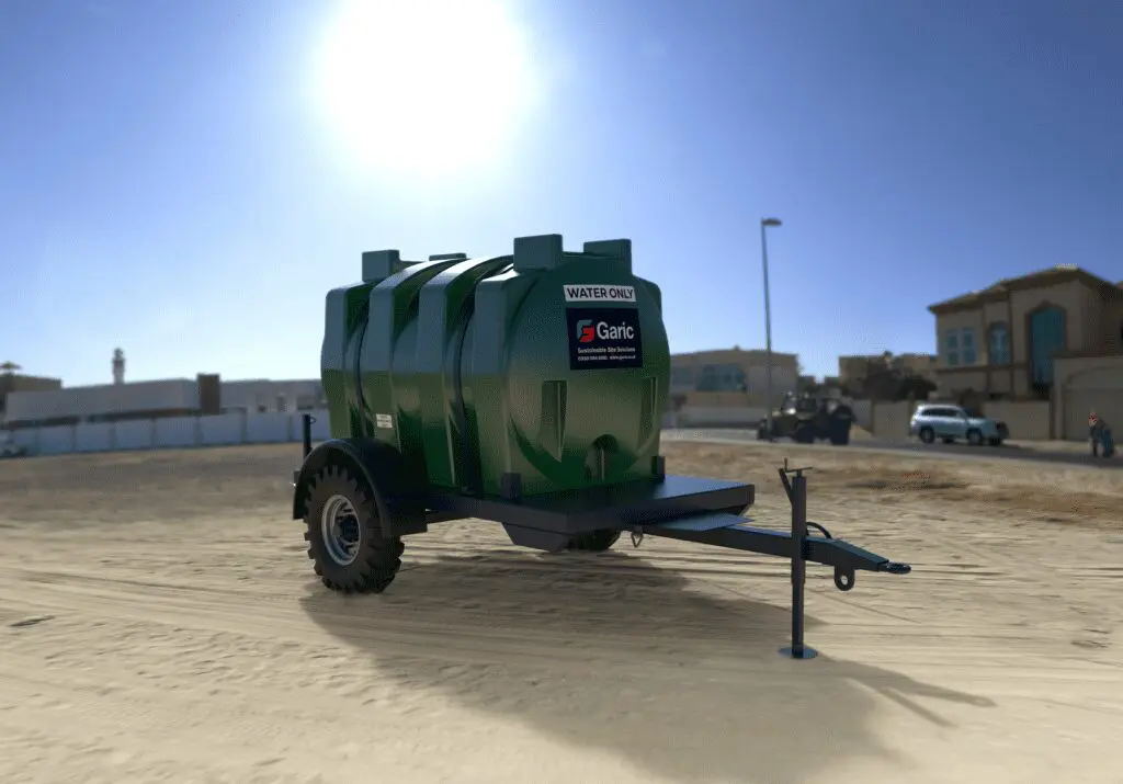A Water Bowser is positioned on sandy ground with buildings and vehicles visible in the background, beneath a bright sky.