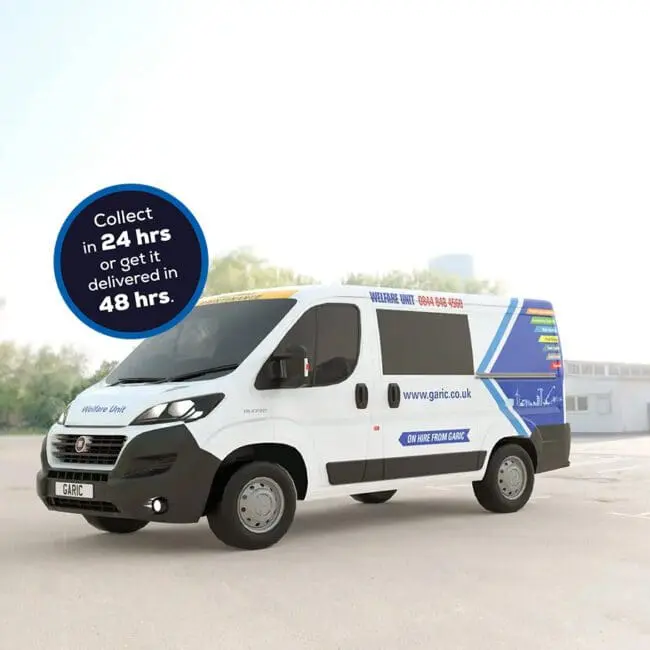 Welfare Van with blue graphics parked outdoors; sign reads “Collect in 24 hrs or get it delivered in 48 hrs.”.