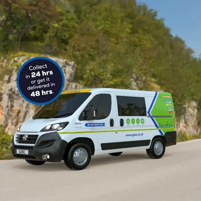 A Welfare Van Eco drives down a road beside a sign that reads “Collect in 24 hrs or get it delivered in 48 hrs.”.