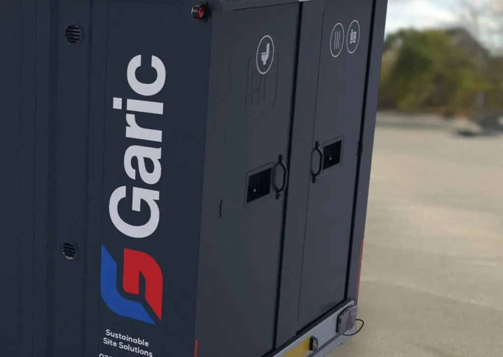 Close-up of an Armadillo 18 unit with logo and icons, situated on a paved outdoor area.