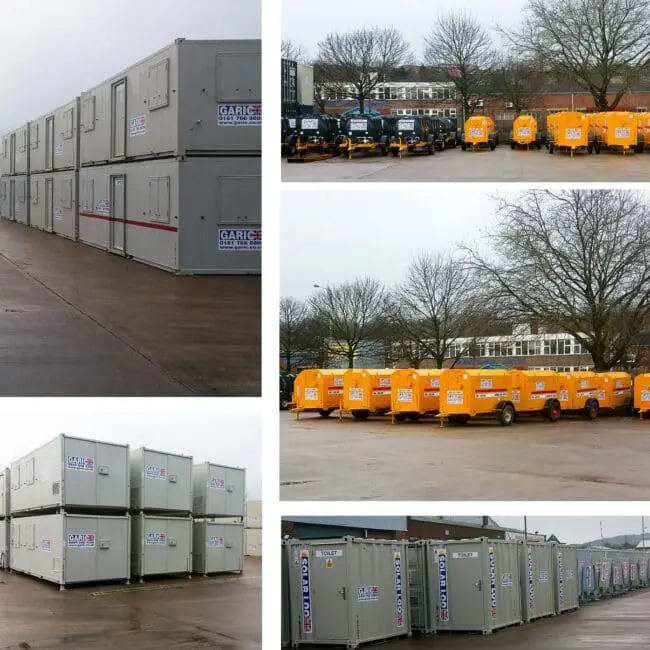 Rows of stacked, grey portable buildings and orange equipment units on a paved lot with bare trees.