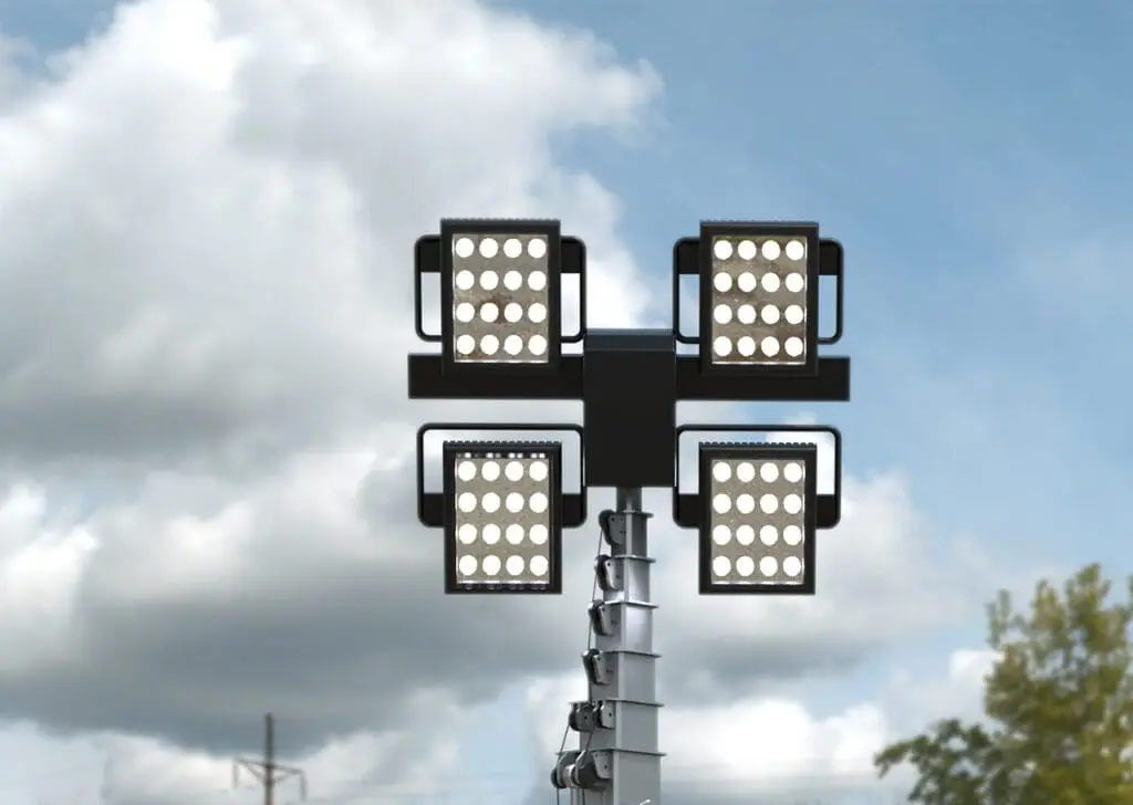 Four Hybrid Tower Lights are mounted on a pole against a partly cloudy sky.