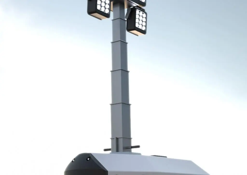 A Hybrid Tower Light stands tall and mobile, featuring four rectangular lamps against a clear sky.