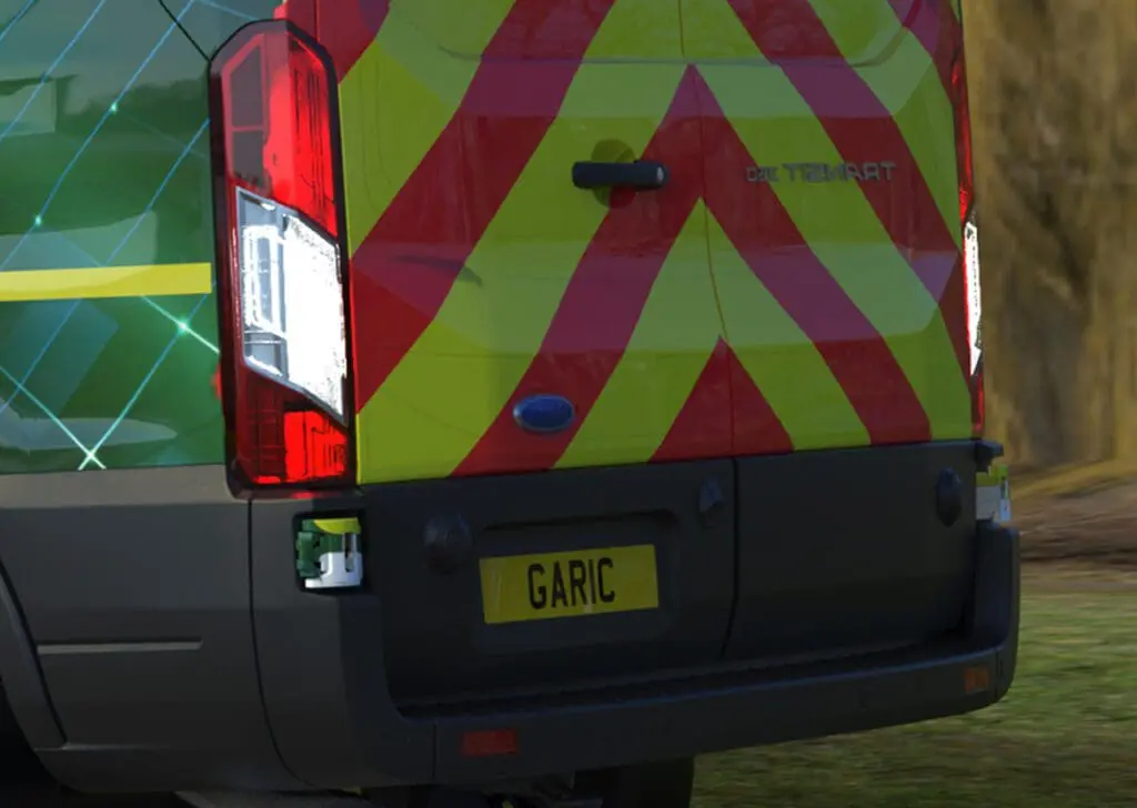 Rear view of the Welfare Van Eco+ with red and yellow chevron stripes and a license plate reading GARIC.
