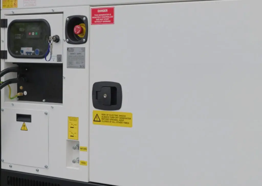 The Armadillo 12 Eco is a white industrial generator featuring caution labels, a control panel, and an emergency stop button.