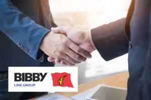 Two people in suits shaking hands, with a Bibby Line Group logo in the foreground.