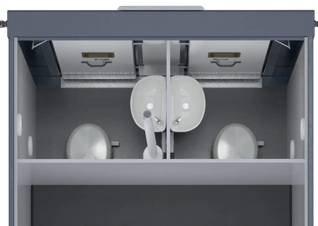 Top view of an Armadillo 18 Eco+ two-stall public restroom, featuring two toilets and two sinks separated by partitions.