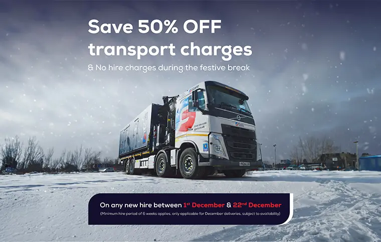 A large truck on a snowy road with a promotion for 50% off transport charges.