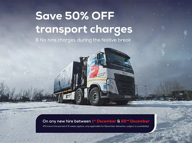 A large truck parked on snow with a 50% off transport charges festive offer displayed above.
