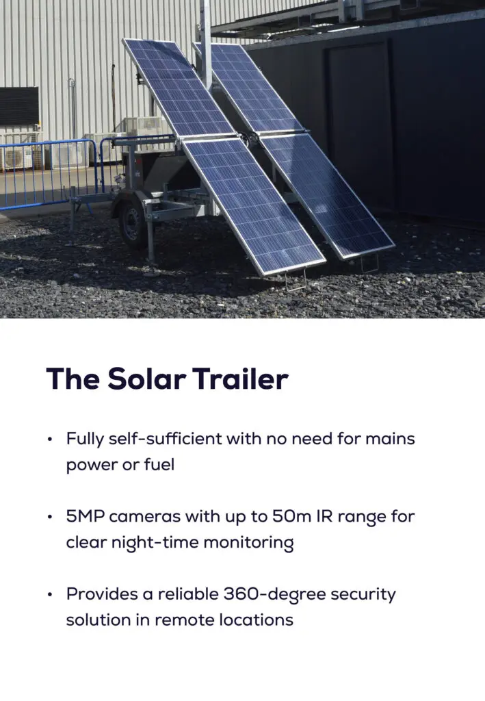 Two solar panels mounted on a trailer, positioned outdoors near a building.