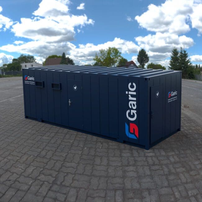 A 4+2 Toilet Block 24 stands on a paved outdoor lot beneath a partly cloudy sky.