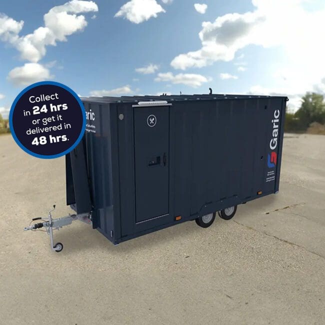 An Armadillo 18 For Hire mobile trailer sits in an open lot, with a sign advertising 24-hour collection or 48-hour delivery.