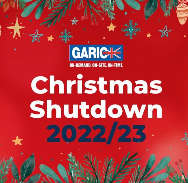 Red festive background with text Christmas Shutdown 2022/23 and holiday decorations and greenery.