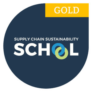 Gold badge for Supply Chain Sustainability School with interlocking blue and green rings in SCHOOL.