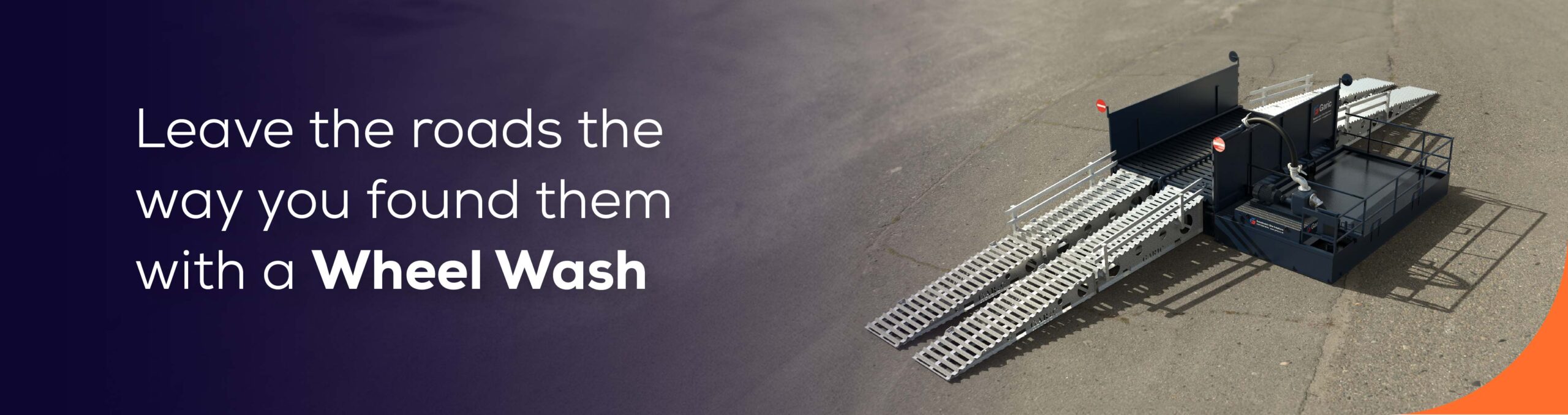 A portable wheel wash system on pavement with text promoting clean roads.