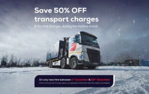 A large truck parked on snow with a 50% off transport charges festive offer displayed above.